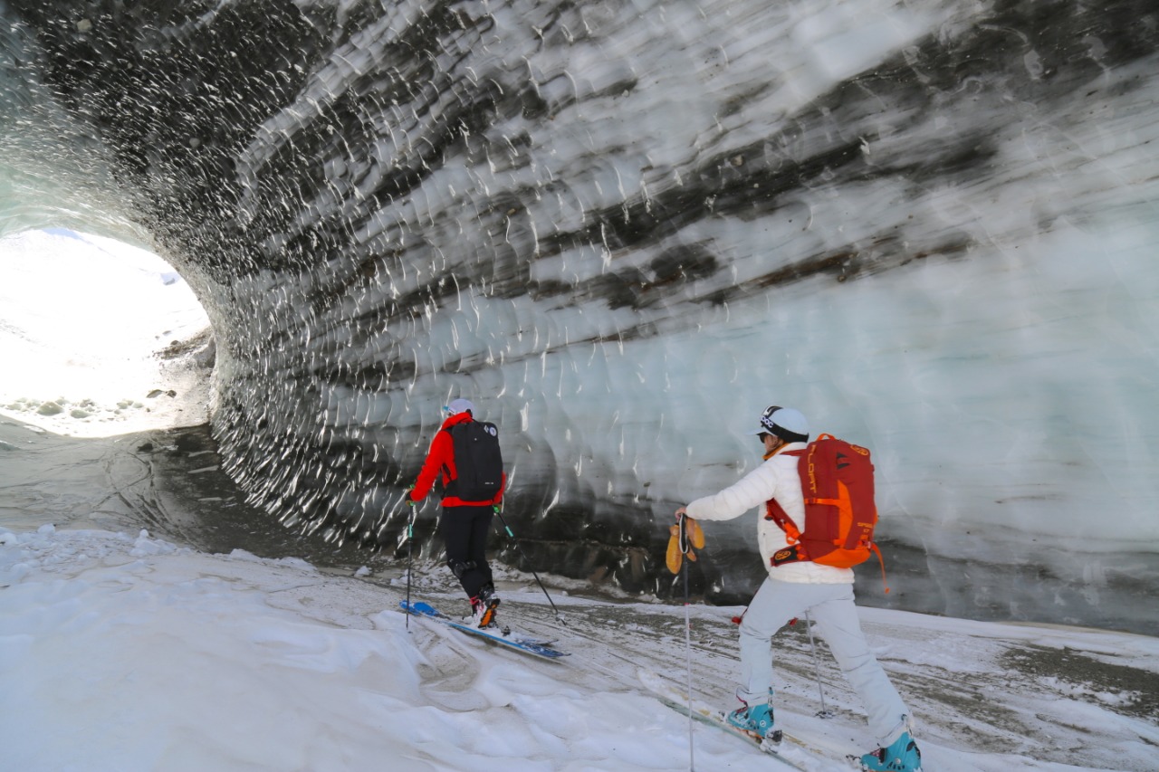 Ski touring through glacial ice cave